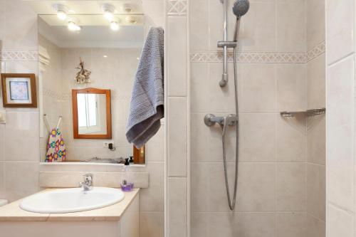 a bathroom with a shower and a sink at Beachfront Bungalow in Torrox Costa