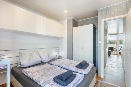 a bedroom with a bed with two pillows on it at Hausboot Joana in Zehdenick