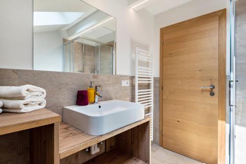 a bathroom with a white sink and a mirror at Haus Lohengrin Ferienwohnung 5 in Siusi