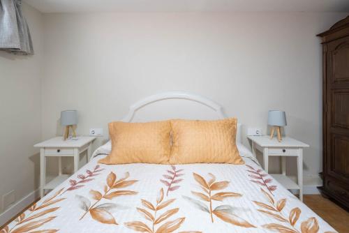 a bedroom with a bed with two night stands at Almar in Vigo