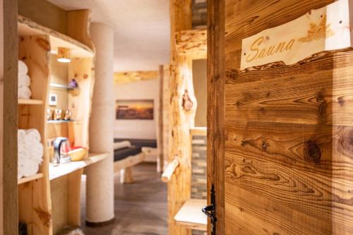a wooden door in a room with a bedroom at Wegscheiderhof Apt Gartenwohnung in Velturno