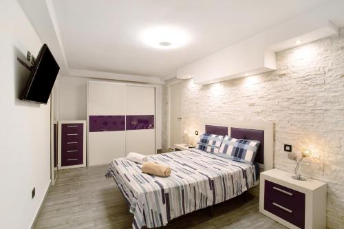 a bedroom with a bed and a brick wall at Apartamento La Burrita in San Agustin