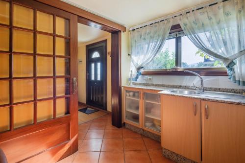 a kitchen with a sink and a window at Casa Nueva de Bueu in Bueu