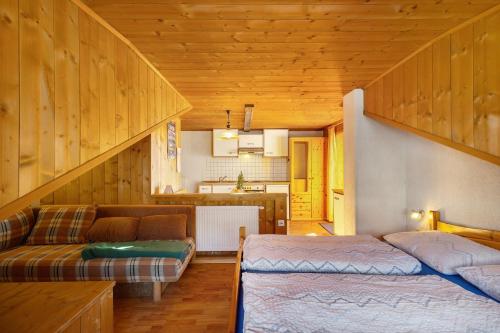 a living room with a bed and a couch at Jelerhof in Gsies