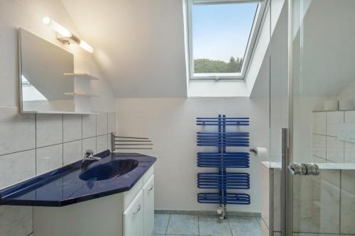 a bathroom with a sink and a window at Ferienhaus Eifellandhaus in Zweifelscheid