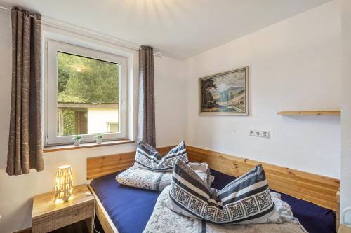a bedroom with a bed and a window at Ferienhaus Eifellandhaus in Zweifelscheid