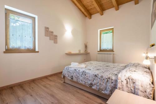 a bedroom with a bed and a window at Nonno Bigi Girasole in Tremosine Sul Garda