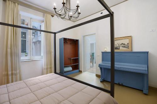 a bedroom with a bed and a blue dresser at Il Cortiletto 21 in Marsala