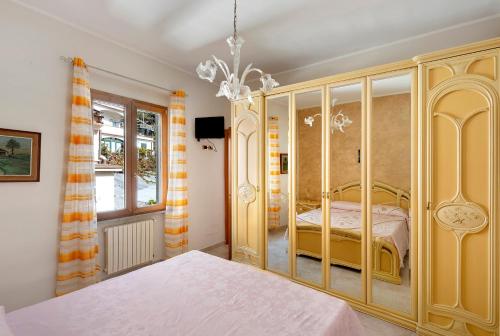 a bedroom with a bed and a chandelier at Ce Tour - Nonni's Lemon House in Cetara