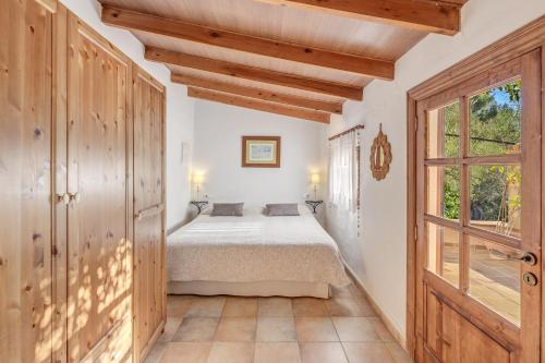 a bedroom with a bed and a window at Miravall in Puigpunyent