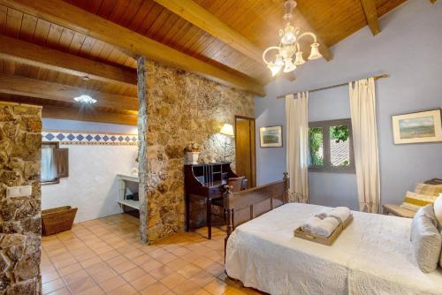 a bedroom with a bed and a desk in a room at La Masia in El Bruc