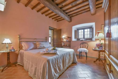 a bedroom with a bed and a table and a chair at Podere Bucigattolo in Serravalle Pistoiese