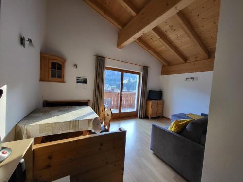 a bedroom with a bed and a couch and a window at Huberhof Mareit in Mareta