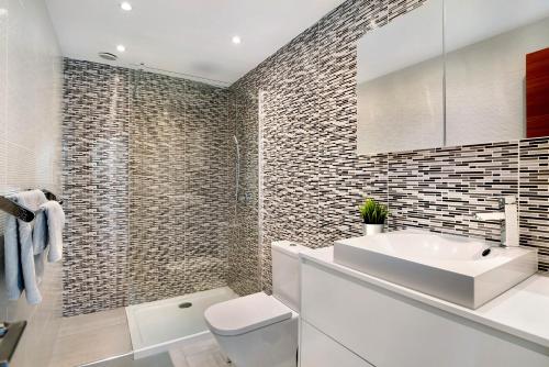 a bathroom with a white sink and a toilet at Villa Khaleesi in Playa Blanca