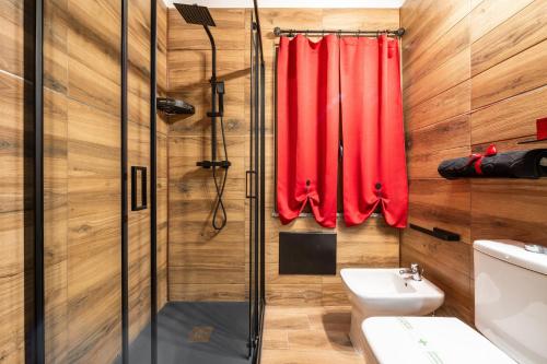 a bathroom with a red shower curtain and a sink at Attilio's House in Capoterra