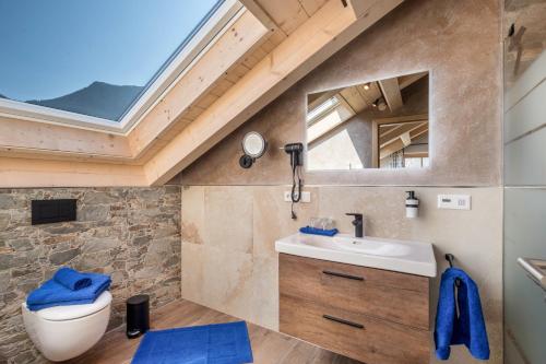 a bathroom with a sink and a skylight at Ferienwohnung Susi im Neubau in Farchant