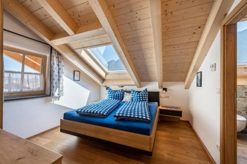 a bedroom in a tiny house with blue pillows at Ferienwohnung Susi im Neubau in Farchant