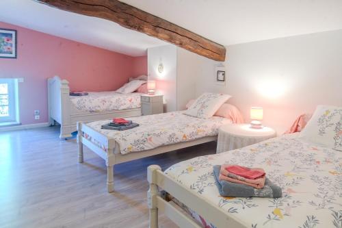 a bedroom with three beds in a room at Le Logis Chez Bompain in Brizambourg