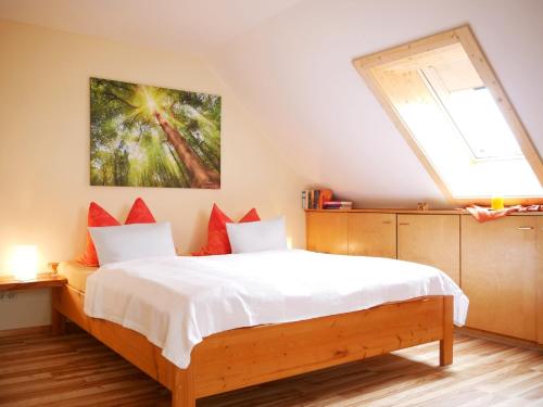 a bedroom with a bed with a large window at Haus Jurisch in Urberg