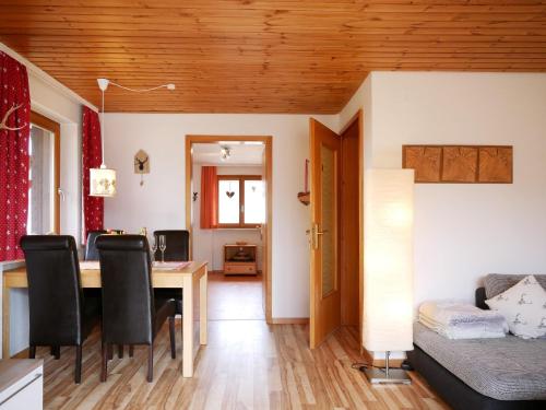 a dining room and living room with a table and chairs at Haus Jurisch in Urberg