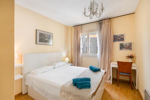 a bedroom with a bed and a desk and a window at Oasis in Sitges