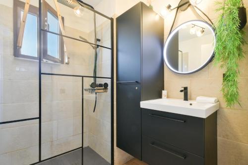 a bathroom with a sink and a mirror at Annecy Garden Spa Billiards in Annecy