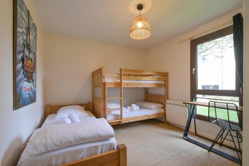 a bedroom with two bunk beds and a desk at Annecy Garden Spa Billiards in Annecy