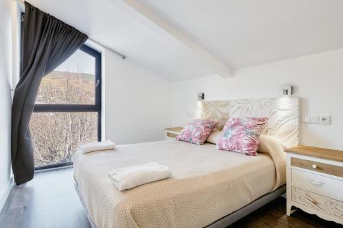 a bedroom with a bed with a large window at Villa Marel in Cerdillo