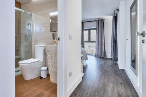 a bathroom with a toilet and a shower and a sink at Villa Marel in Cerdillo