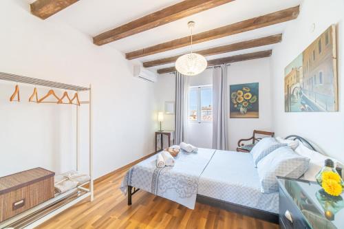 a white bedroom with a bed and a window at Contessa di Corfu ii in Corfu