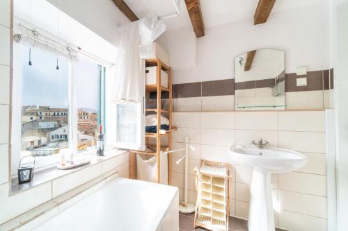 a bathroom with a sink and a window at Contessa di Corfu ii in Corfu