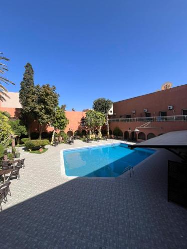 a swimming pool in front of a building at Hotel Tiznit in Tiznit