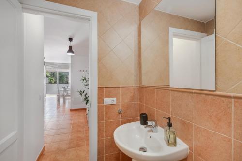 a bathroom with a sink and a mirror at Vv Estrella in Puerto de Mogán