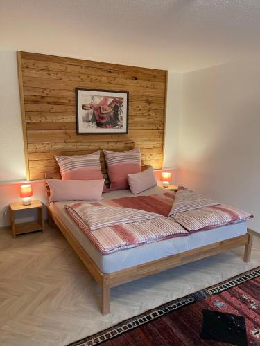 a bedroom with a large bed with two lamps on it at Ferienparadies Bodensee Fewo1 in Owingen