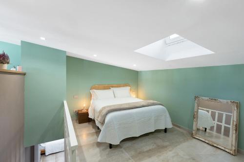a bedroom with a bed and a mirror at Civico 32 in Salerno