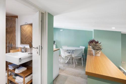 a bathroom with a sink and a counter with a table at Civico 32 in Salerno