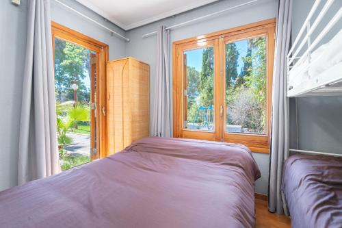 a bedroom with a bed and a window at Ilusion in Olocau