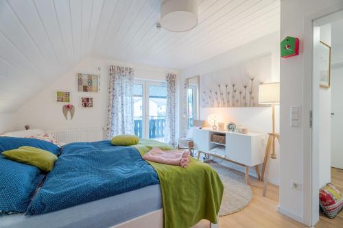 a bedroom with a blue bed and a desk at Onkel Franz in Ohlsbach