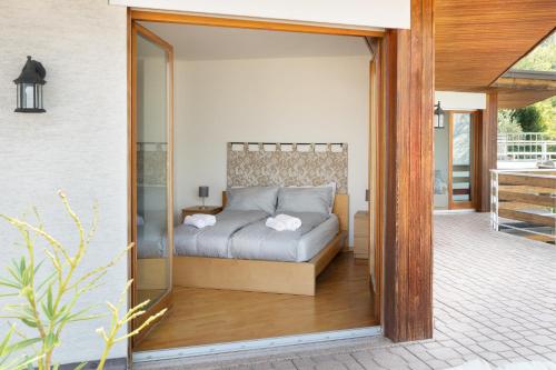 a bedroom with a bed inside of a glass door at Panorama Apartment 180 mq in Nago-Torbole