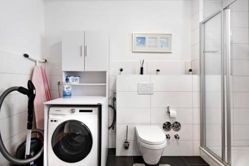 a white bathroom with a washing machine in it at B5fewo in Bad Bellingen