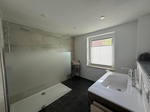 a bathroom with a tub and a sink and a shower at Ferienwohnung S Keller in Plankenfels