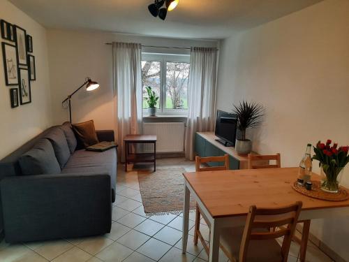 a living room with a couch and a table at Ferienwohnung No15 in Pfullendorf