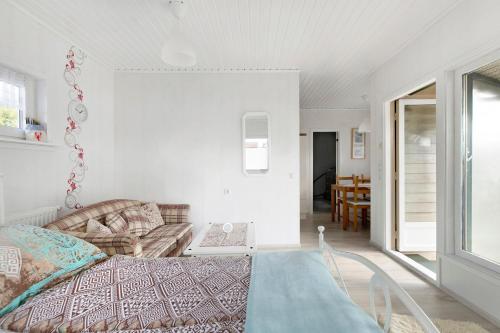 a bedroom with a bed and a living room at Kleines Schweden in Hennstedt