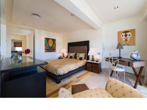 a bedroom with a bed and a desk at Chalet en la playa San Agustin in Maspalomas