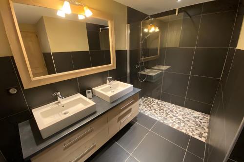 a bathroom with two sinks and a mirror at Les Craterelles 3 - 1650 in Courchevel