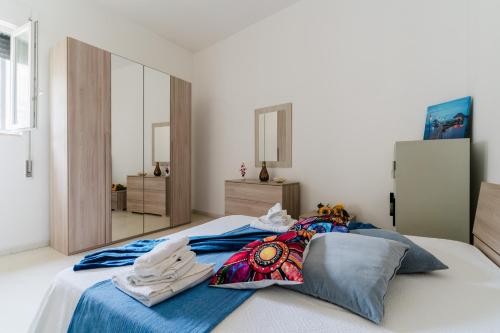 a bedroom with a large bed with blue sheets at Casa Elaia 4 posti a Cannole in Cannole