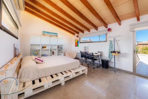 a bedroom with a bed and a desk at Ca Na Xisca in Sa Pobla