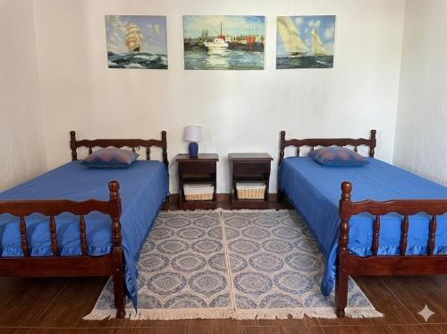 two beds in a room with paintings on the wall at Мечта in Kruče