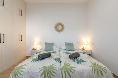 a bedroom with a large bed with two pillows on it at Vista Valle in La Orotava