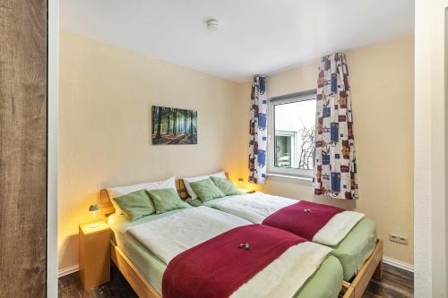 a bedroom with a bed and a window at Ferienwohnung Holterhoff in Olpe